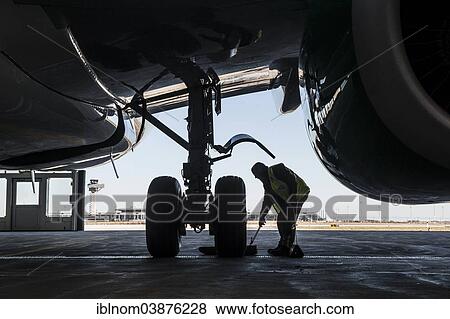 "Man working on the undercarriage of an aircraft, Airport Berlin Brandenburg International, BBI, Berlin, Germany, Europe" View Large Photo Image Stock Photo - "Man working on the undercarriage of an aircraft, Airport Berlin Brandenburg International, BBI, Berlin, Germany, Europe". Fotosearch