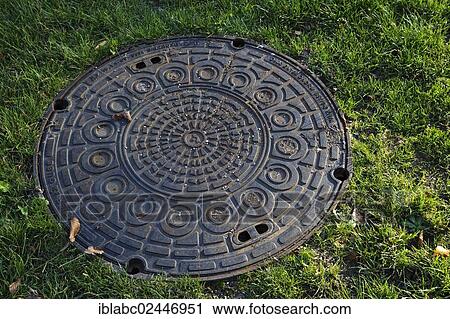 Stock Image - "Manhole cover in the Ostfriedhof or East Cemetery, Munich, Bavaria, Germany, Europe". Fotosearch