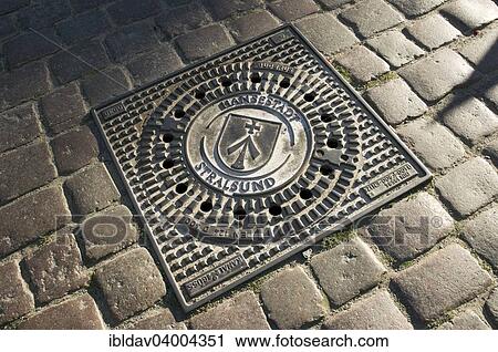 Stock Image - "Manhole cover, Stralsund, Mecklenburg Vorpommern, Germany, Europe". Fotosearch