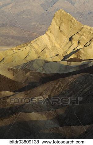 Stock Photo - "Manly Beacon in the morning light, a rocky outcrop in the badlands below Zabriskie Point, Death Valley National Park, California, USA". Fotosearch