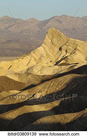 Stock Photo - "Manly Beacon in the morning light, a rocky outcrop in the badlands below Zabriskie Point, Death Valley National Park, California, USA". Fotosearch