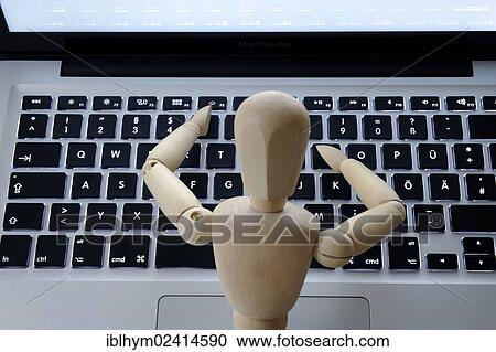 Stock Image - Mannequin at the keyboard, symbolic image for human beings and computers. Fotosearch