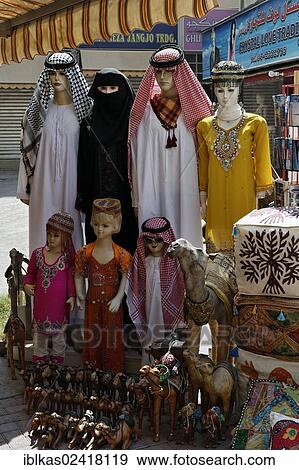 Mannequins wearing traditional Arabic clothing for sale, for women, men and children, Deira, Old Souk, Dubai, United Arab Emirates, Middle East, Asia View Large Photo Image Stock Photo - Mannequins wearing traditional Arabic clothing for sale, for women, men and children, Deira, Old Souk, Dubai, United Arab Emirates, Middle East, Asia. Fotosearch