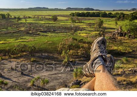 "Man's legs with view of Nadab floodplain, Nadab lookout, Ubirr, East Alligator region, Northern Territory, Australia, Oceania" View Large Photo Image Stock Photo - "Man's legs with view of Nadab floodplain, Nadab lookout, Ubirr, East Alligator region, Northern Territory, Australia, Oceania". Fotosearch