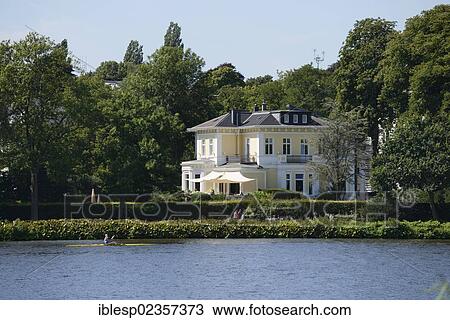 "Mansion with a rowing boat at front on the Aussenalster or Outer Alster Lake, Hamburg, Hamburg, Germany, Europe" View Large Photo Image Stock Image - "Mansion with a rowing boat at front on the Aussenalster or Outer Alster Lake, Hamburg, Hamburg, Germany, Europe". Fotosearch