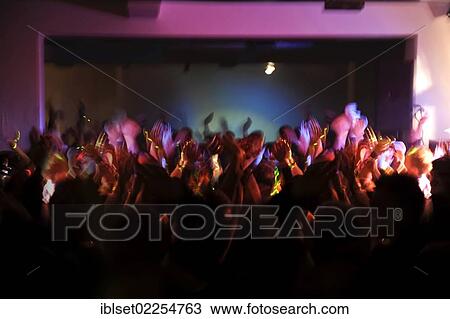 "Many young people on the dance floor in a nightclub or discotheque, holding hands in the air" View Large Photo Image Stock Image - "Many young people on the dance floor in a nightclub or discotheque, holding hands in the air". Fotosearch