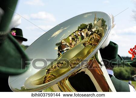 Picture - "Marching band reflected in a tuba, Leonhardiritt procession, Harmating, Egling, Upper Bavaria, Bavaria, Germany, Europe". Fotosearch