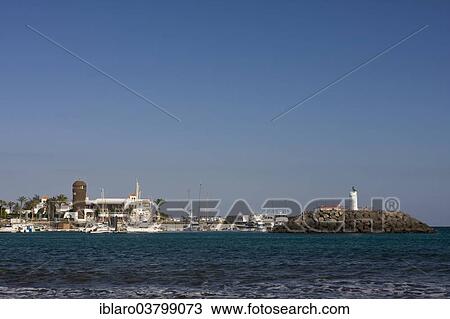 "Marina with lighthouse in Caleta de Fuste, Fuerteventura, Canary Islands, Spain, Europe" View Large Photo Image Stock Image - "Marina with lighthouse in Caleta de Fuste, Fuerteventura, Canary Islands, Spain, Europe". Fotosearch