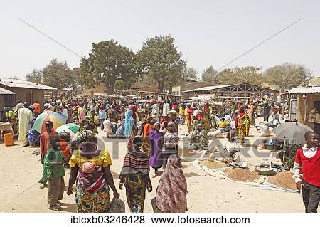 Stock Photo - "Market scene, women wearing colourful dresses, selling millet, Tourou, Far North, Cameroon, Africa". Fotosearch