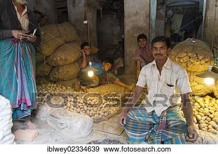 "Market trader sitting between potatoes and jute bags, spice market, Old Dhaka, Dhaka, Bangladesh, South Asia, Asia" View Large Photo Image Stock Photo - "Market trader sitting between potatoes and jute bags, spice market, Old Dhaka, Dhaka, Bangladesh, South Asia, Asia". Fotosearch