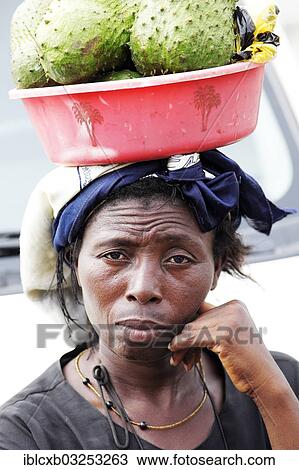 "Market woman carrying fruit on her head, Dschang, West Region, Cameroon, Africa" View Large Photo Image Stock Image - "Market woman carrying fruit on her head, Dschang, West Region, Cameroon, Africa". Fotosearch