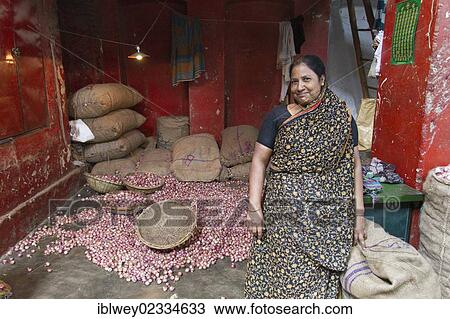 "Market woman standing in front of her shop, jute bags full of onions at back, spice market, Old Dhaka, Dhaka, Bangladesh, South Asia, Asia" View Large Photo Image Stock Image - "Market woman standing in front of her shop, jute bags full of onions at back, spice market, Old Dhaka, Dhaka, Bangladesh, South Asia, Asia". Fotosearch