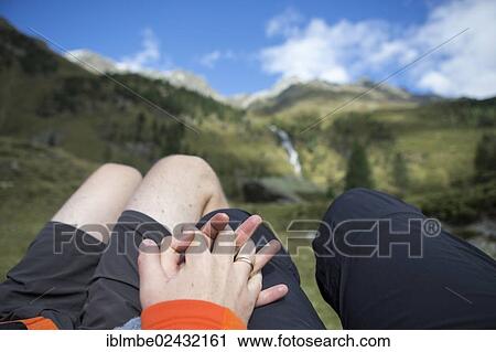 "Married couple holding each other's hands while overlooking a mountain panorama, Debanttal Valley, Tyrol, Austria, Europe" View Large Photo Image Stock Image - "Married couple holding each other's hands while overlooking a mountain panorama, Debanttal Valley, Tyrol, Austria, Europe". Fotosearch