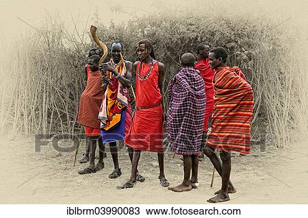 Stock Image - "Masai in front of their boma, Maasai Mara National Reserve, Kenya, Africa". Fotosearch
