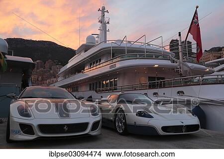 "Maserati and Ferrari in front of the motoryacht """"Siran"""" in Port Hercule at twilight, Furstentum Monaco, Monaco, Monaco, Europe" View Large Photo Image Picture - "Maserati and Ferrari in front of the motoryacht """"Siran"""" in Port Hercule at twilight, Furstentum Monaco, Monaco, Monaco, Europe". Fotosearch