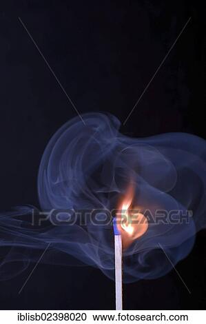 Stock Image - "Matchstick being ignited, with blue smoke". Fotosearch