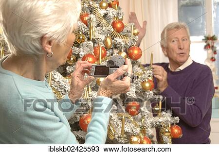Mature couple filming themselves at the Christmas tree View Large Photo Image Stock Image - Mature couple filming themselves at the Christmas tree. Fotosearch