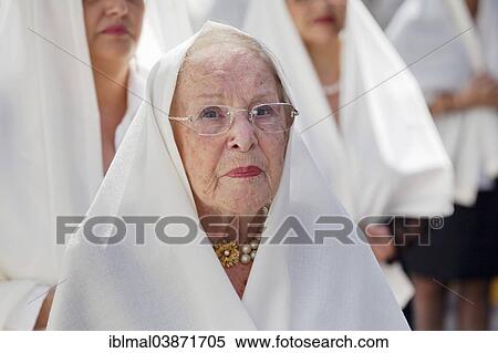 Stock Photography - "Mature woman taking part in the Easter procession in the historic centre of Vegueta, Las Palmas, Gran Canaria, Canary Islands, Spain, Europe". Fotosearch