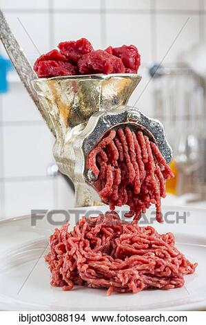 "Meat-grinder, grinding fresh meat into minced meat" View Large Photo Image Picture - "Meat-grinder, grinding fresh meat into minced meat". Fotosearch