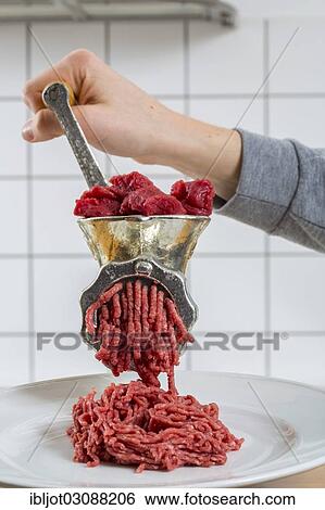 "Meat-grinder, grinding fresh meat into minced meat" View Large Photo Image Stock Photograph - "Meat-grinder, grinding fresh meat into minced meat". Fotosearch
