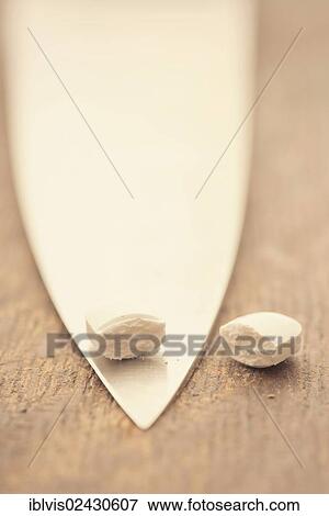 Medical capsule divided into two halves by large knife View Large Photo Image Stock Photo - Medical capsule divided into two halves by large knife. Fotosearch