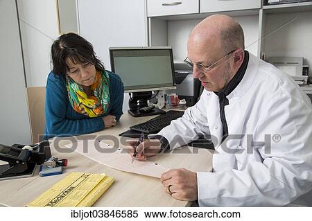 Stock Photography - "Medical practice, doctor talking to a patient about an ECG finding, Germany, Europe". Fotosearch