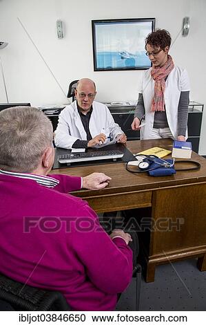 "Medical practice, elderly patient talking to his doctor and the assistant, Germany, Europe" View Large Photo Image Stock Image - "Medical practice, elderly patient talking to his doctor and the assistant, Germany, Europe". Fotosearch