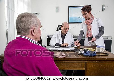 "Medical practice, elderly patient talking to his doctor and the assistant, Germany, Europe" View Large Photo Image Stock Image - "Medical practice, elderly patient talking to his doctor and the assistant, Germany, Europe". Fotosearch