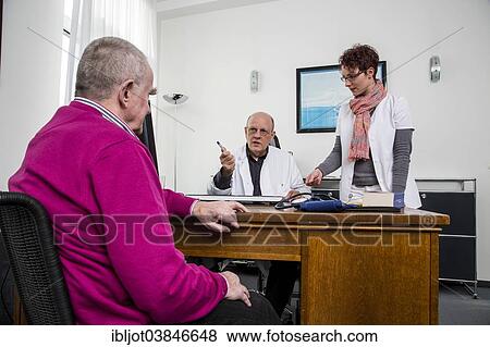 "Medical practice, elderly patient talking to his doctor and the assistant, Germany, Europe" View Large Photo Image Stock Photo - "Medical practice, elderly patient talking to his doctor and the assistant, Germany, Europe". Fotosearch