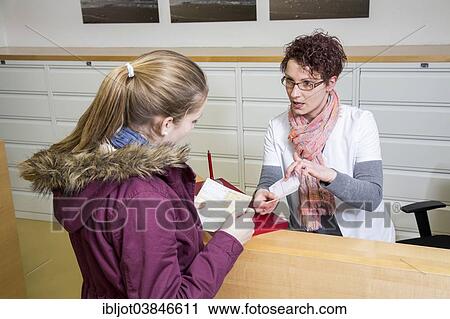 "Medical practice, the receptionist handing over a referral to a doctor and a prescription to the patient, at the front desk, electronic health card, Germany, Europe" View Large Photo Image Stock Image - "Medical practice, the receptionist handing over a referral to a doctor and a prescription to the patient, at the front desk, electronic health card, Germany, Europe". Fotosearch