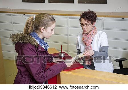 "Medical practice, the receptionist handing over a referral to specialist to a patient, Germany, Europe" View Large Photo Image Stock Image - "Medical practice, the receptionist handing over a referral to specialist to a patient, Germany, Europe". Fotosearch
