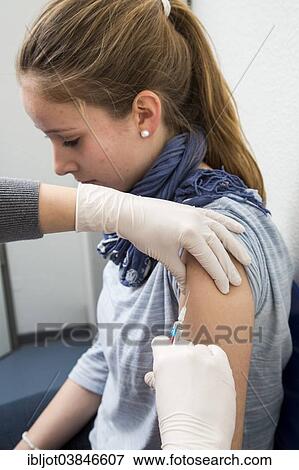 "Medical practice, young woman getting a flu shot, influenza vaccine, Germany, Europe" View Large Photo Image Stock Photo - "Medical practice, young woman getting a flu shot, influenza vaccine, Germany, Europe". Fotosearch
