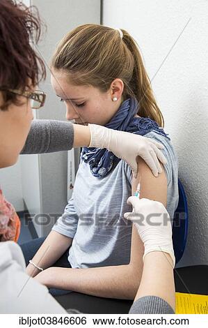 "Medical practice, young woman getting a flu shot, influenza vaccine, Germany, Europe" View Large Photo Image Stock Photograph - "Medical practice, young woman getting a flu shot, influenza vaccine, Germany, Europe". Fotosearch