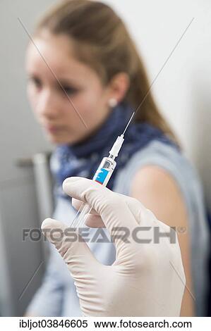 "Medical practice, young woman getting a flu shot, influenza vaccine, Germany, Europe" View Large Photo Image Stock Photography - "Medical practice, young woman getting a flu shot, influenza vaccine, Germany, Europe". Fotosearch