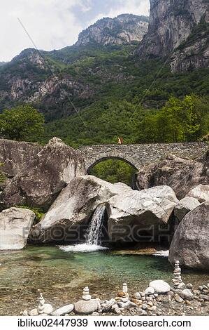 "Medieval bridge with hikers near Fontana, Bavona Valley, Val Bavona, Maggia Valley, Valle Maggia, Ticino, Switzerland, Europe" View Large Photo Image Stock Photo - "Medieval bridge with hikers near Fontana, Bavona Valley, Val Bavona, Maggia Valley, Valle Maggia, Ticino, Switzerland, Europe". Fotosearch