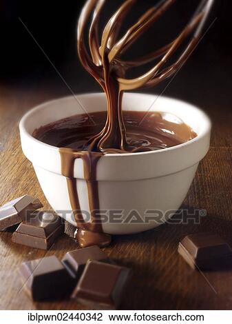 Stock Image - Melted chocolate being stirred in a bowl. Fotosearch