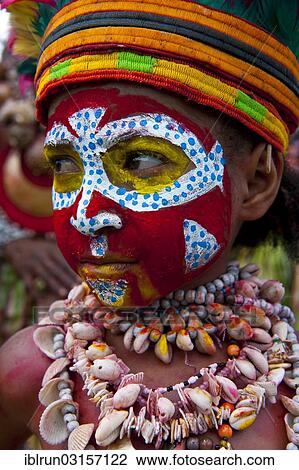 Stock Image - "Member of a tribe in a colourfully decorated costume with face paint at the traditional sing-sing gathering, Hochland, Mount Hagen, Western Highlands Province, Papua New Guinea, Oceania". Fotosearch