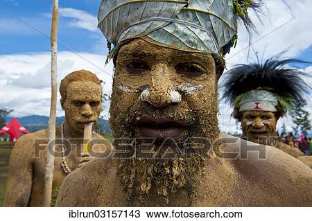 Stock Image - "Member of a tribe in a colourfully decorated costume with face and body paint at the traditional sing-sing gathering, Hochland, Mount Hagen, Western Highlands Province, Papua New Guinea, Oceania". Fotosearch