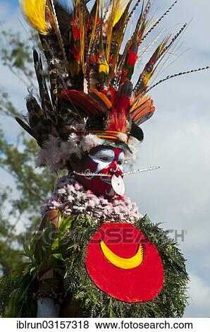 Stock Photo - "Member of a tribe in a colourfully decorated costume with face paint at the traditional sing-sing gathering, Hochland, Mount Hagen, Western Highlands Province, Papua New Guinea, Oceania". Fotosearch