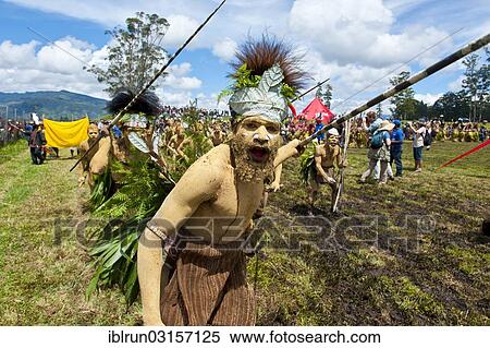 "Member of a tribe in a colourfully decorated costume with face and body paint at the traditional sing-sing gathering, Hochland, Mount Hagen, Western Highlands Province, Papua New Guinea, Oceania" View Large Photo Image Stock Photography - "Member of a tribe in a colourfully decorated costume with face and body paint at the traditional sing-sing gathering, Hochland, Mount Hagen, Western Highlands Province, Papua New Guinea, Oceania". Fotosearch