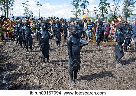 "Members of a tribe covered in black paint at the traditional sing-sing gathering, Hochland, Mount Hagen, Western Highlands Province, Papua New Guinea, Oceania" View Large Photo Image Picture - "Members of a tribe covered in black paint at the traditional sing-sing gathering, Hochland, Mount Hagen, Western Highlands Province, Papua New Guinea, Oceania". Fotosearch