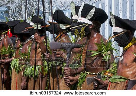 Picture - "Members of a tribe in colourfully decorated costumes with face paint at the traditional sing-sing gathering, Hochland, Mount Hagen, Western Highlands Province, Papua New Guinea, Oceania". Fotosearch