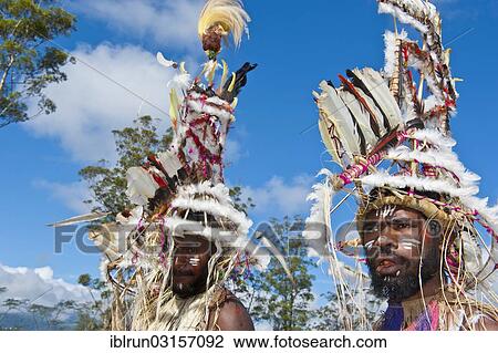 Stock Image - "Members of a tribe in colourfully decorated costumes with face paint at the traditional sing-sing gathering, Hochland, Mount Hagen, Western Highlands Province, Papua New Guinea, Oceania". Fotosearch