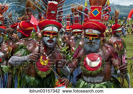 Stock Image - "Members of a tribe in colourfully decorated costumes with face paint at the traditional sing-sing gathering, Hochland, Mount Hagen, Western Highlands Province, Papua New Guinea, Oceania". Fotosearch