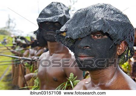 "Members of a tribe with black painted faces at the traditional sing-sing gathering, Hochland, Mount Hagen, Western Highlands Province, Papua New Guinea, Oceania" View Large Photo Image Stock Photo - "Members of a tribe with black painted faces at the traditional sing-sing gathering, Hochland, Mount Hagen, Western Highlands Province, Papua New Guinea, Oceania". Fotosearch