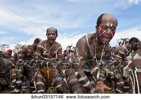 Stock Photograph - "Members of a tribe with face and body paint at the traditional sing-sing gathering, Hochland, Mount Hagen, Western Highlands Province, Papua New Guinea, Oceania". Fotosearch