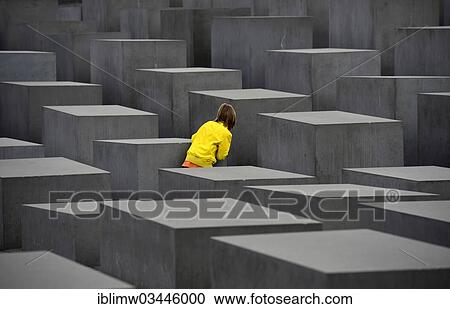 Stock Image - "Memorial to the Murdered Jews of Europe, child playing hide and seek at the Holocaust Memorial designed by architect Peter Eisenman, Friedrichstadt, Berlin, Berlin, Germany, Europe". Fotosearch