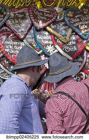 Stock Photography - "Men buying an Oktoberfest ginger heart, Oktoberfest, Munich, Bavaria, Germany, Europe". Fotosearch