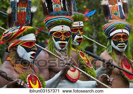 Stock Image - "Men in colourfully decorated costumes with face paint are celebrating at the traditional Sing Sing gathering in the highlands, Paya, Papua New Guinea, Oceania". Fotosearch