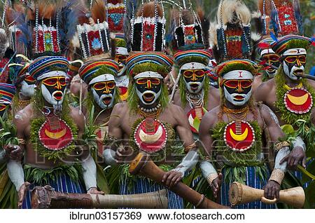 "Men in colourfully decorated costumes with face paint are celebrating at the traditional Sing Sing gathering in the highlands, Paya, Papua New Guinea, Oceania" View Large Photo Image Stock Photo - "Men in colourfully decorated costumes with face paint are celebrating at the traditional Sing Sing gathering in the highlands, Paya, Papua New Guinea, Oceania". Fotosearch